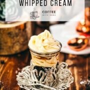 Delicious espresso whipped cream served on top of a coffee in a medieval styled glass cup.