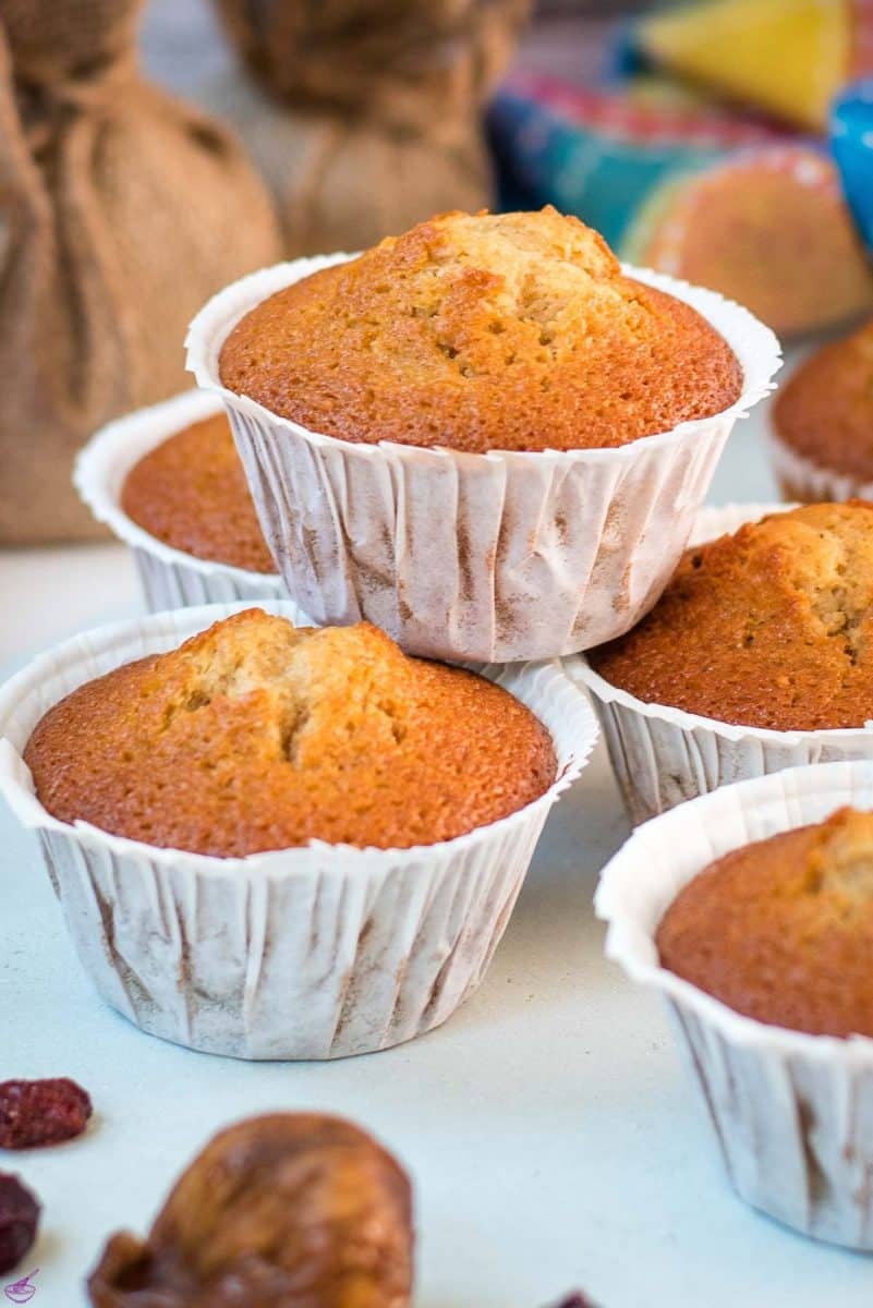 Delicious, and very easy to make, fruit cake muffins, filled with dried figs and dried cranberries. Placed on white plate.