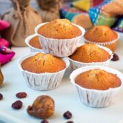 Delicious, and very easy to make, fruit cake muffins, filled with dried figs and dried cranberries. Placed on white plate.