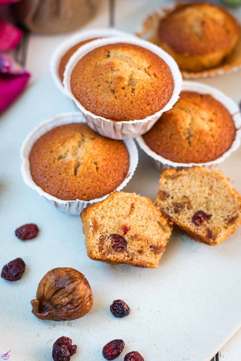 Delicious, and very easy to make, fruit cake muffins, filled with dried figs and dried cranberries. Placed on white plate.