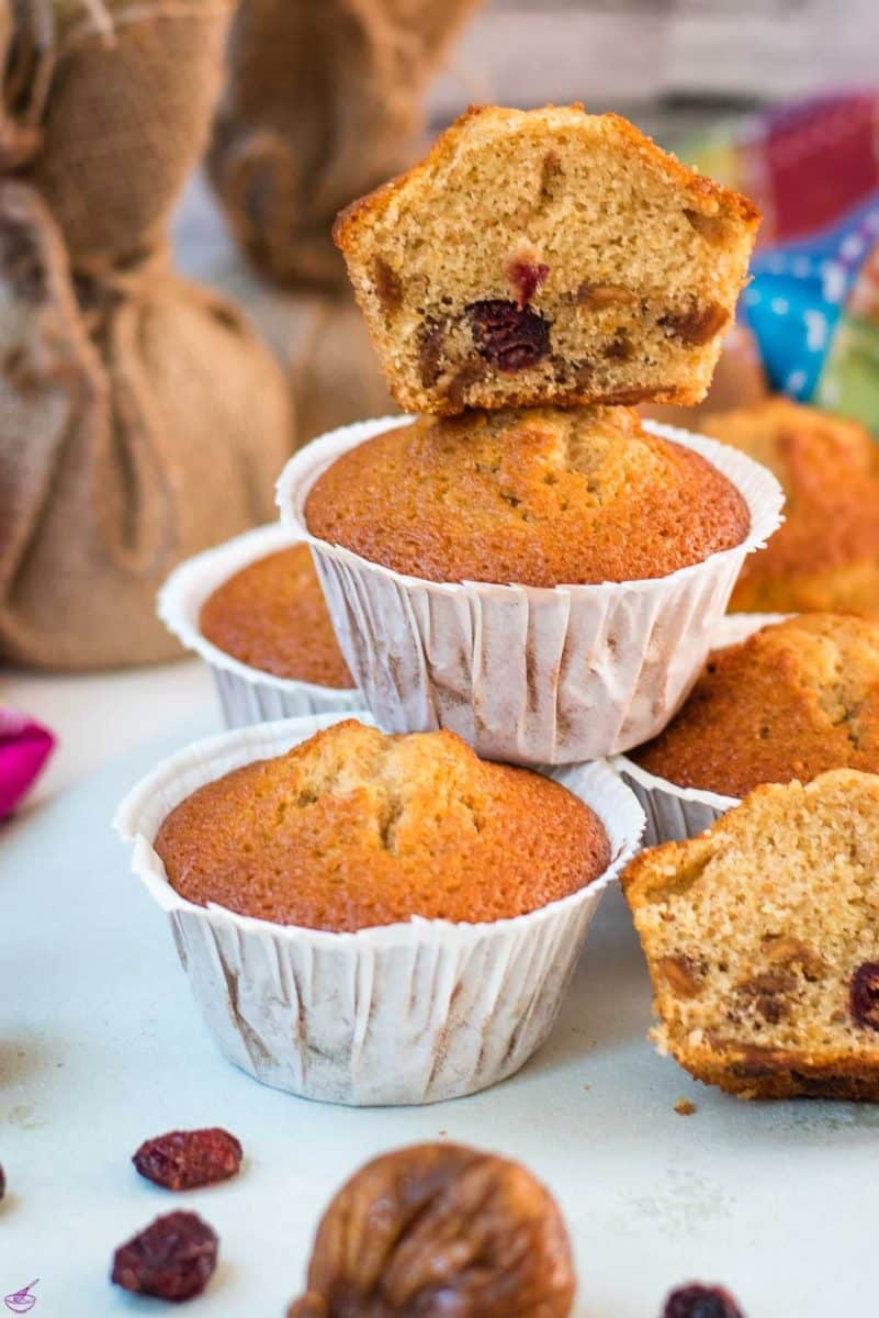 Delicious, and very easy to make, fruit cake muffins, filled with dried figs and dried cranberries. Placed on white plate.