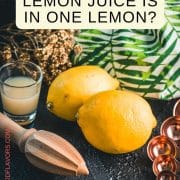 Lemons, placed on dark ground next to lemon juice and lemon squeezer.