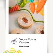 Gorgeous vegan Easter cut out cookies with apricot jam, placed on a white stone plate