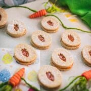 Gorgeous vegan Easter cut out cookies with apricot jam, placed on a white stone plate