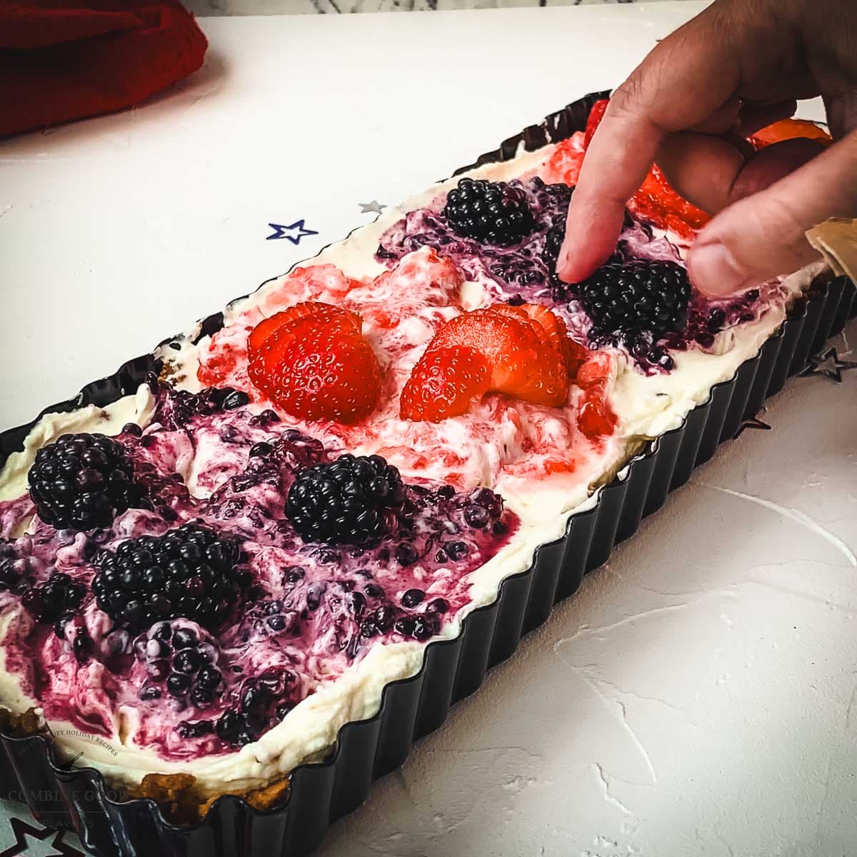 Place fresh blackberries and strawberries on top of the tart.