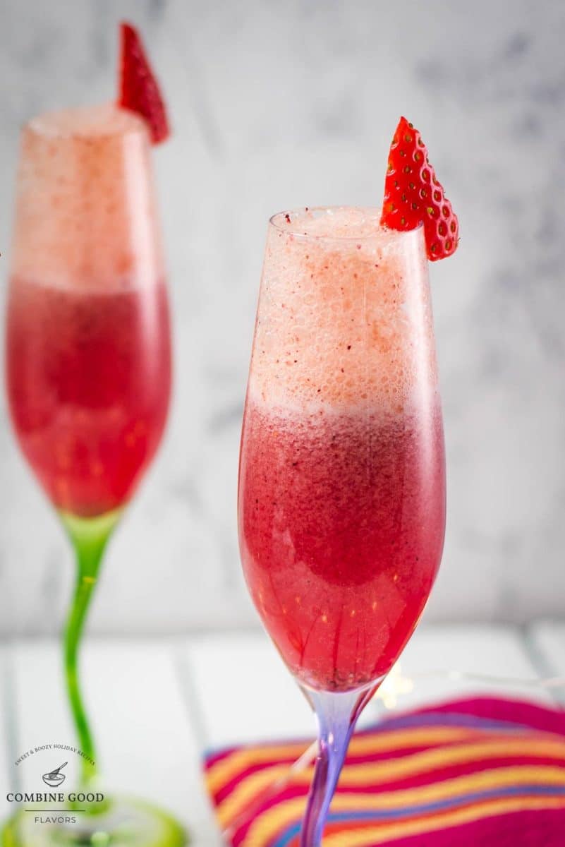 Gorgeous colored champagne flutes filled with vibrant berry mimosa.