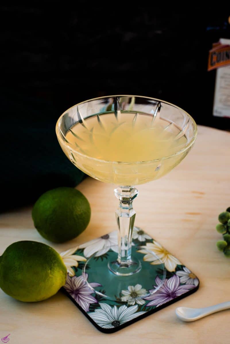 Gorgeous silky Margarita, served in cocktail glass and placed on coaster with flower pattern.