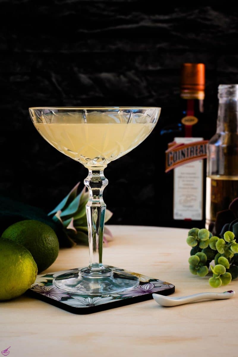 Gorgeous silky Margarita, served in cocktail glass and placed on coaster with flower pattern.