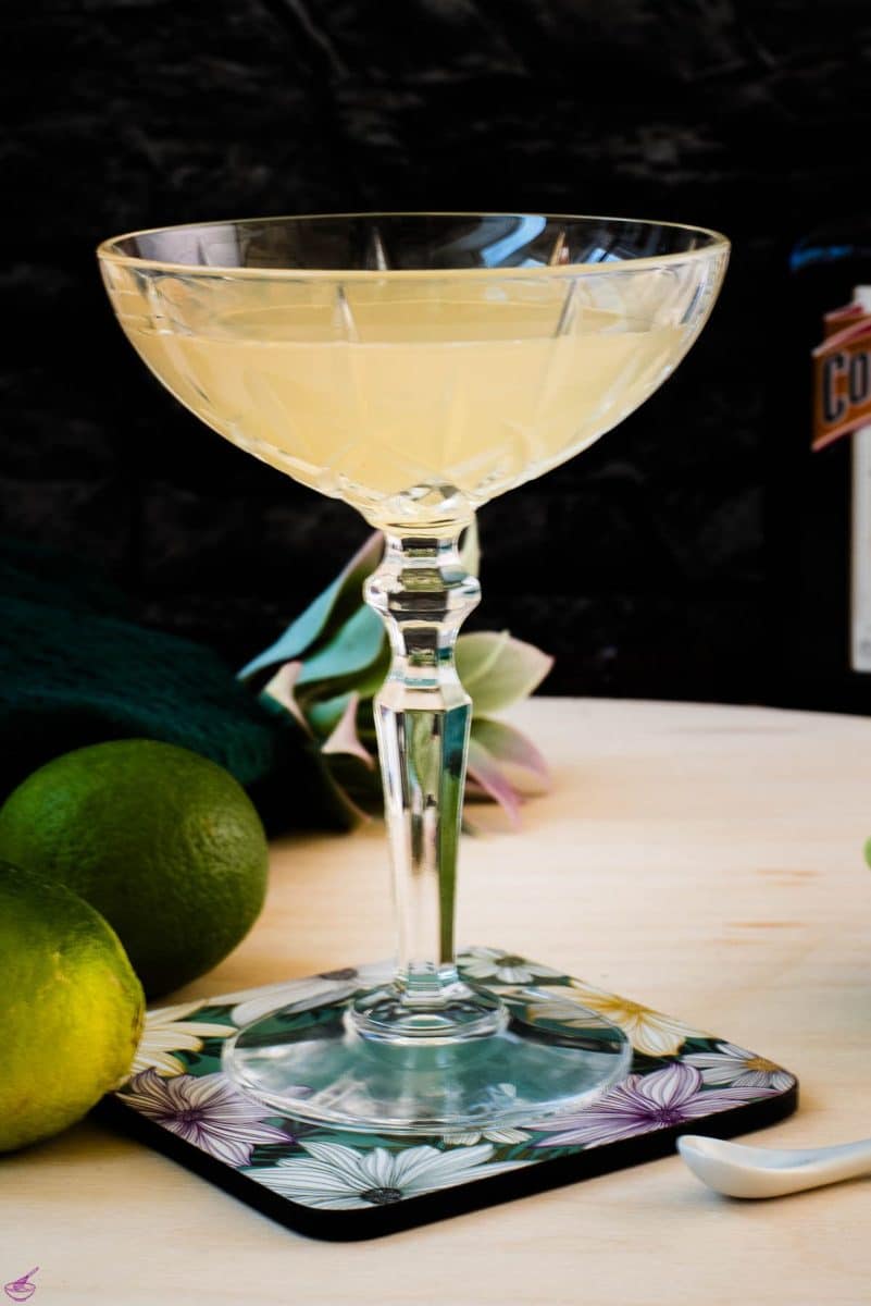 Gorgeous silky Margarita, served in cocktail glass and placed on coaster with flower pattern.