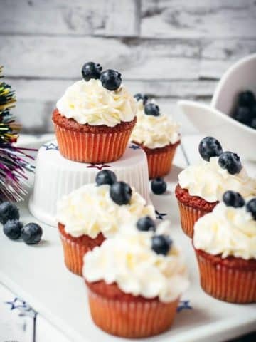 Gorgeous red, white and blue cupcakes, placed on white plate.