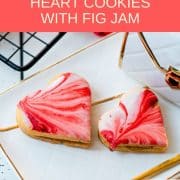 Gorgeous heart shaped sugar cookies with marbled icing, and filled with fig jam. Placed on gorgeous white golden serving plate.