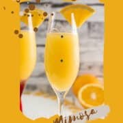 Gorgeous mimosa, garnished with orange slice in cute glass with small gems.