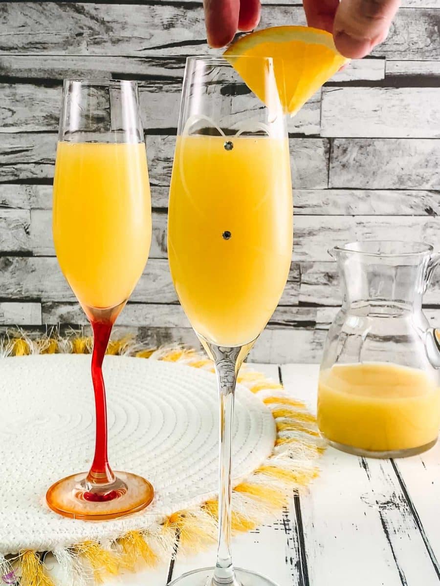 Garnish your classic mimosa with a little orange slice.