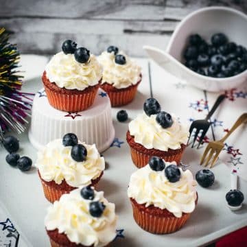 Gorgeous red, white and blue cupcakes, placed on white plate.