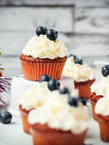 Gorgeous red, white and blue cupcakes, placed on white plate.