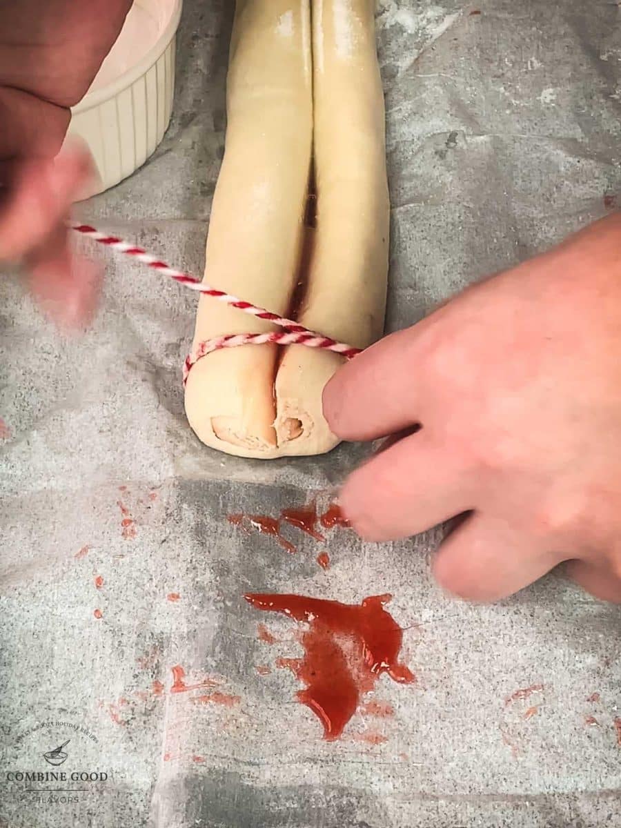 Cut the puff pastry roll using a kitchen twine.