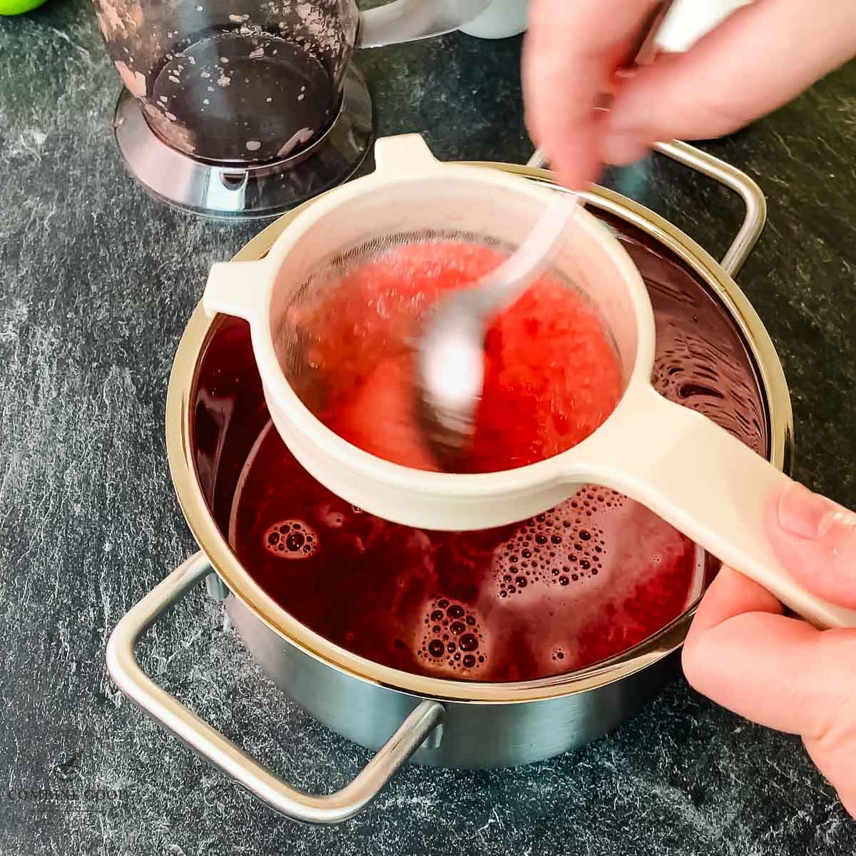 Pass the watermelon puree through a fine-mesh sieve using a spoon.