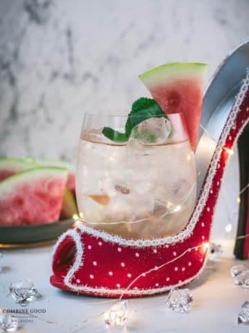 Delicious watermelon spritz with Prosecco placed in a red and white spotted high heel.