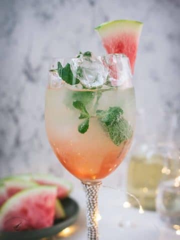 Gorgeous wine glass filled with watermelon spritzer.