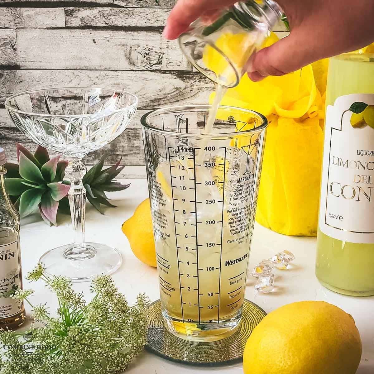 Adding lemon juice to the cocktail shaker.