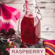 Preserving bottle, filled with delicious uncooked raspberry syrup placed on a marbled plate.