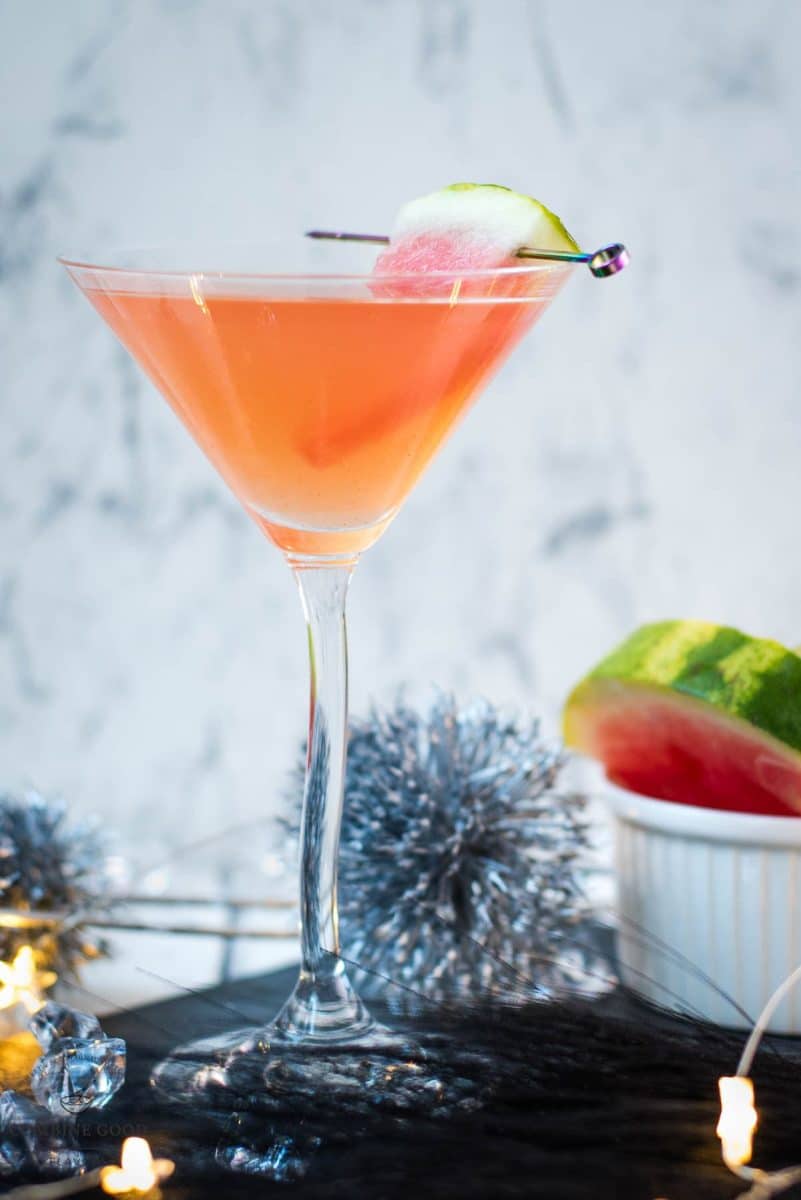 Gorgeous watermelon martini with a watermelon garnish, placed on a black slate plate.