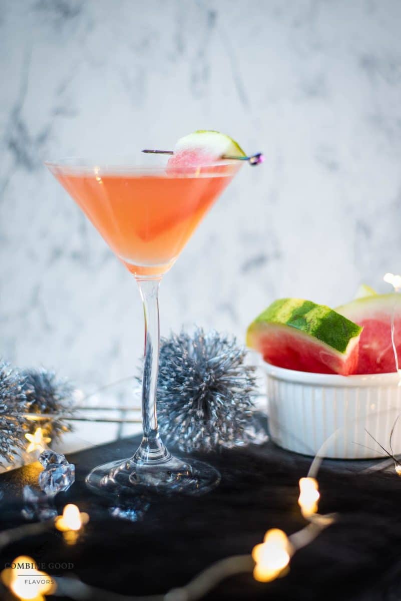 Gorgeous watermelon martini with a watermelon garnish, placed on a black slate plate.