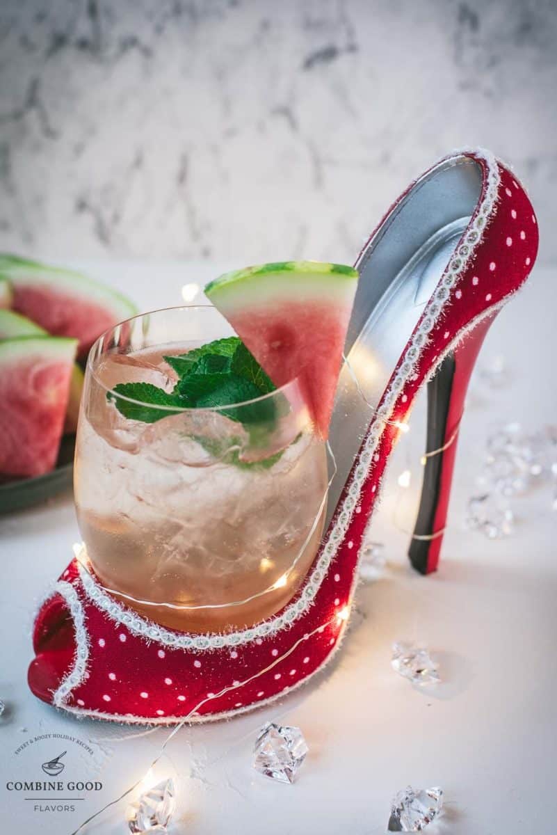 Delicious watermelon spritz with Prosecco placed in a red and white spotted high heel.