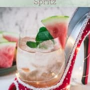 Delicious watermelon spritz with Prosecco placed in a red and white spotted high heel.