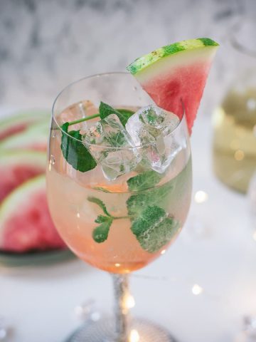 Gorgeous wine glass filled with watermelon spritzer.