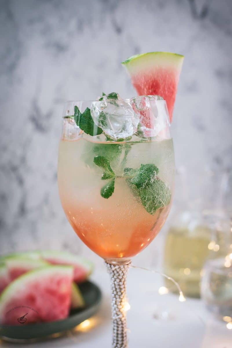 Gorgeous wine glass filled with watermelon spritzer.