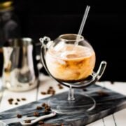 Gorgeous marbled cold brew white Russian made with half-and-half, placed on marbled plate.
