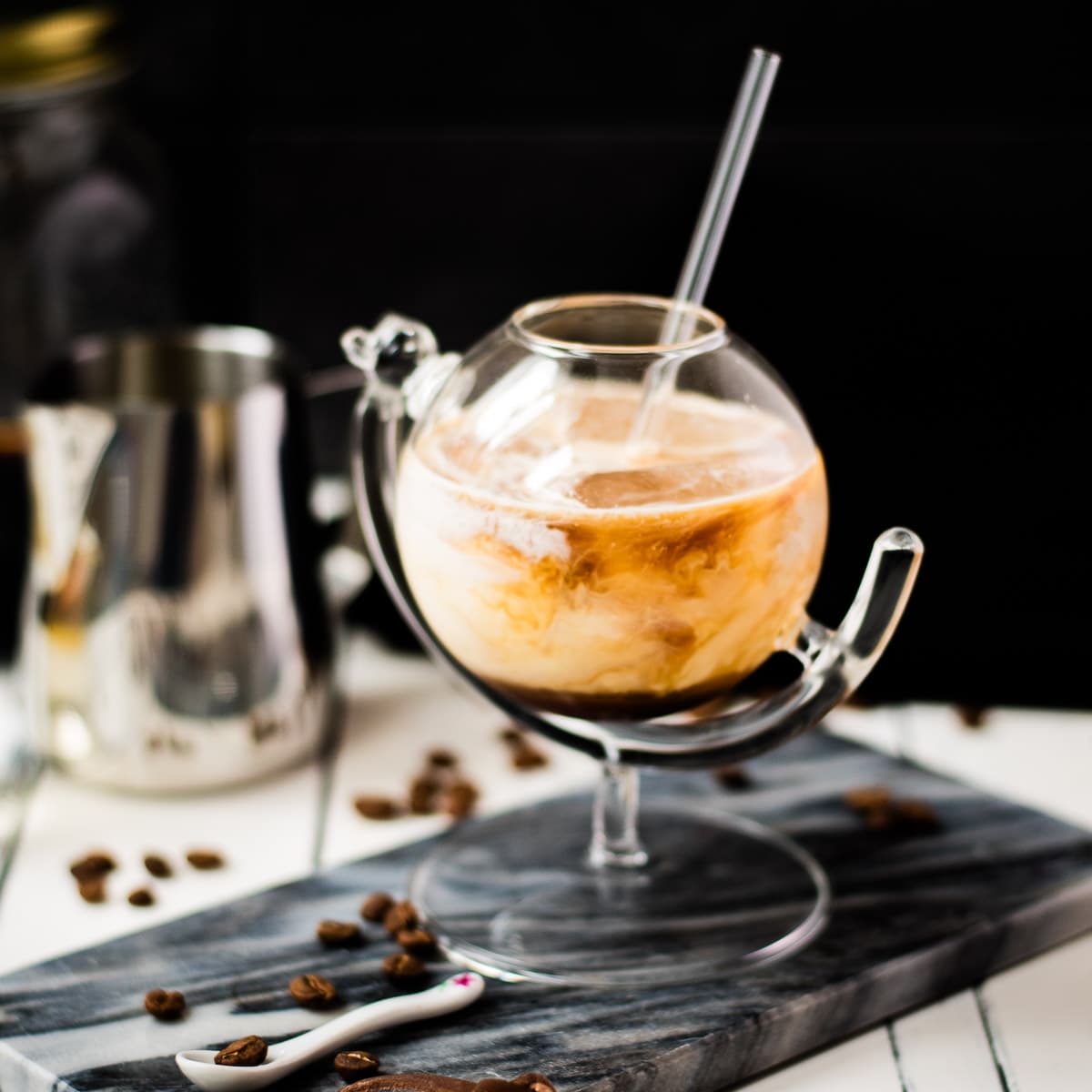 Gorgeous marbled cold brew white Russian made with half-and-half, placed on marbled plate.