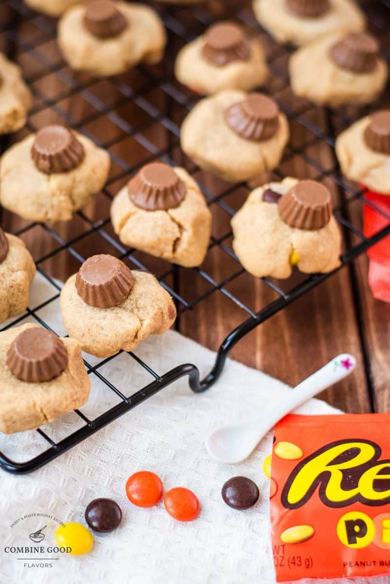 Utterly delicious Reese's peanut butter cookies placed on a cppling rack, with a Reese's peanut butter mini cup on top.