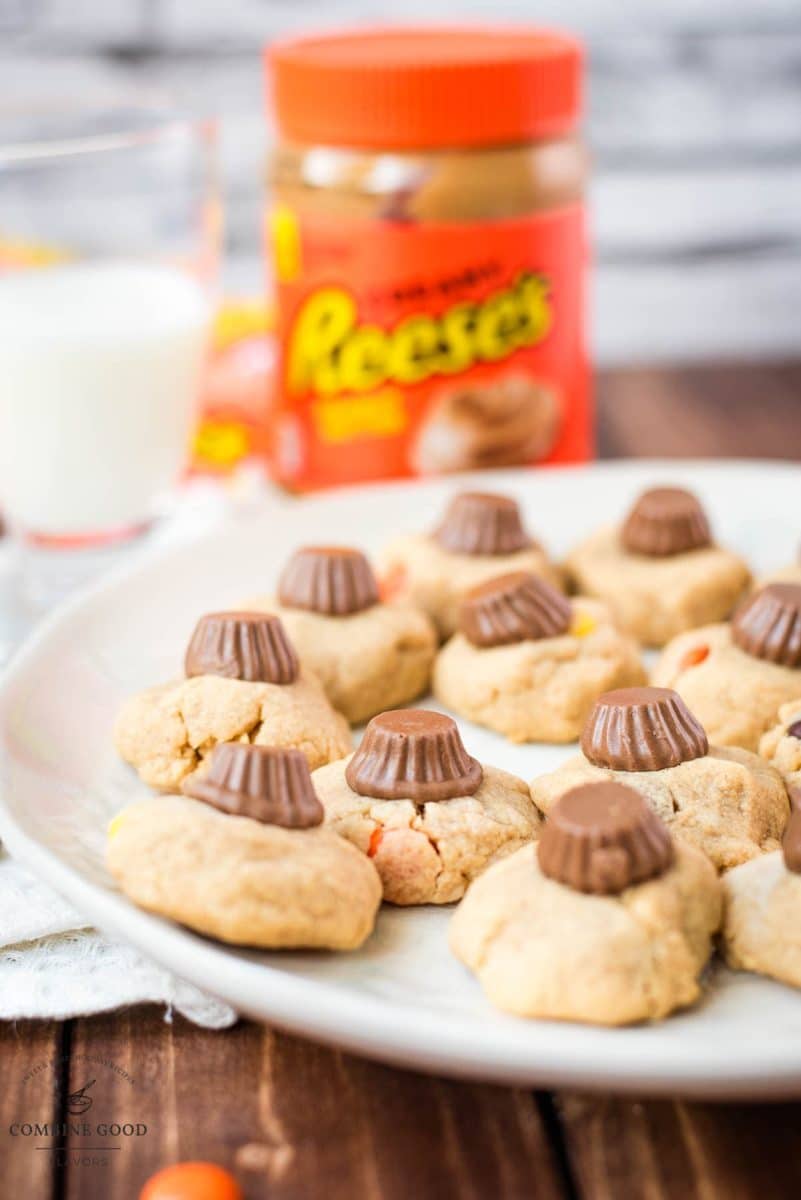 Utterly delicious Reese's peanut butter cookies served on a white plate, with a Reese's peanut butter mini cup on top.