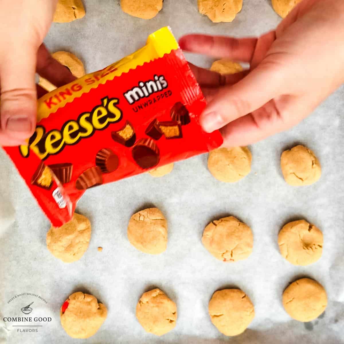 Hands holding the pack of Reese's peanut butter mini cups.