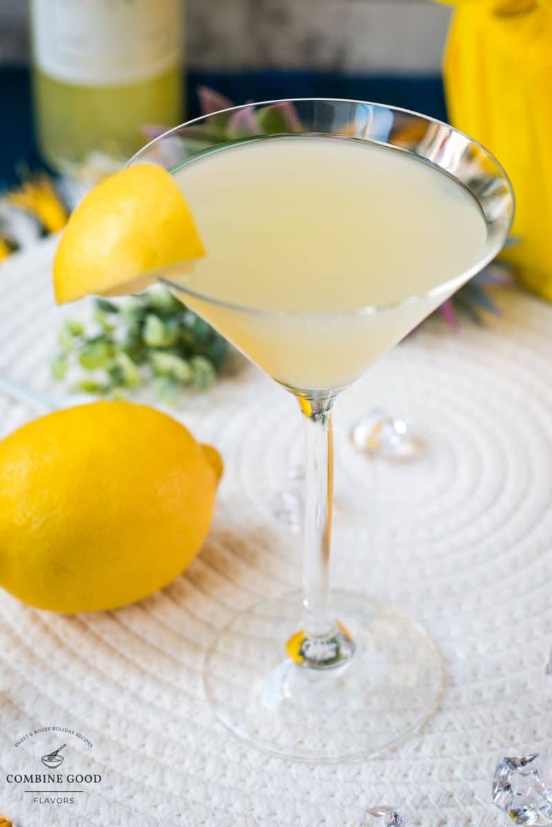 Gorgeous cocktail glass filled with a vibrant limoncello martini, garnished with a lemon wedge.