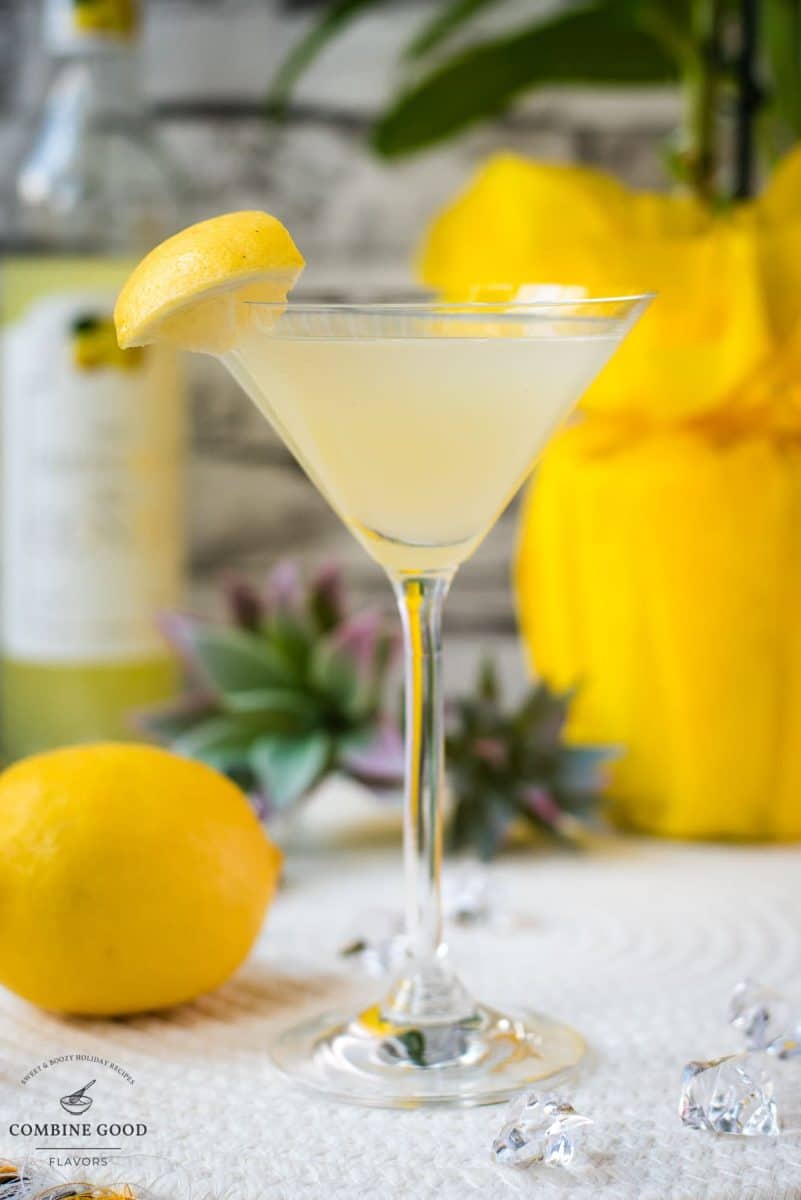 Gorgeous cocktail glass filled with a vibrant limoncello martini, garnished with a lemon wedge.