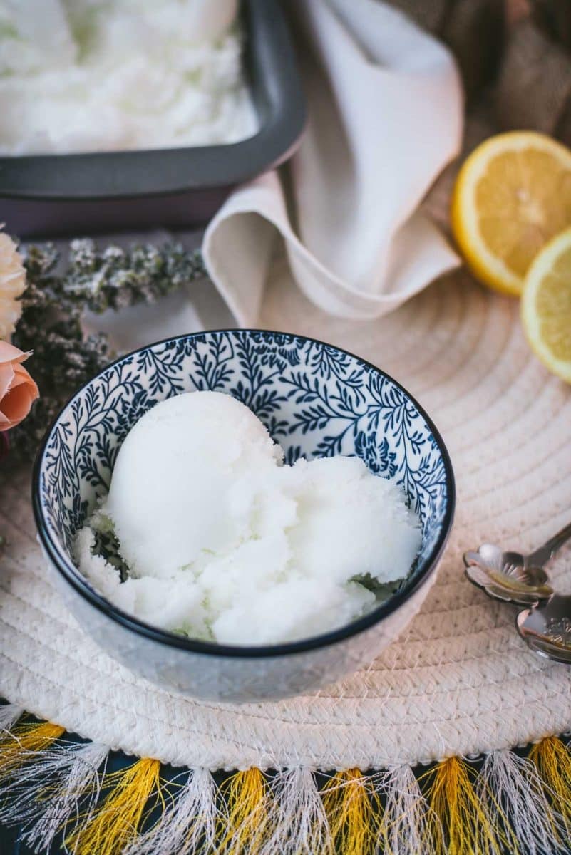 Delicious lemon sorbet served in white and blue patterned bowl.