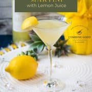 Gorgeous cocktail glass filled with a vibrant limoncello martini, garnished with a lemon wedge.