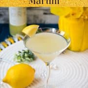 Gorgeous cocktail glass filled with a vibrant limoncello martini, garnished with a lemon wedge.