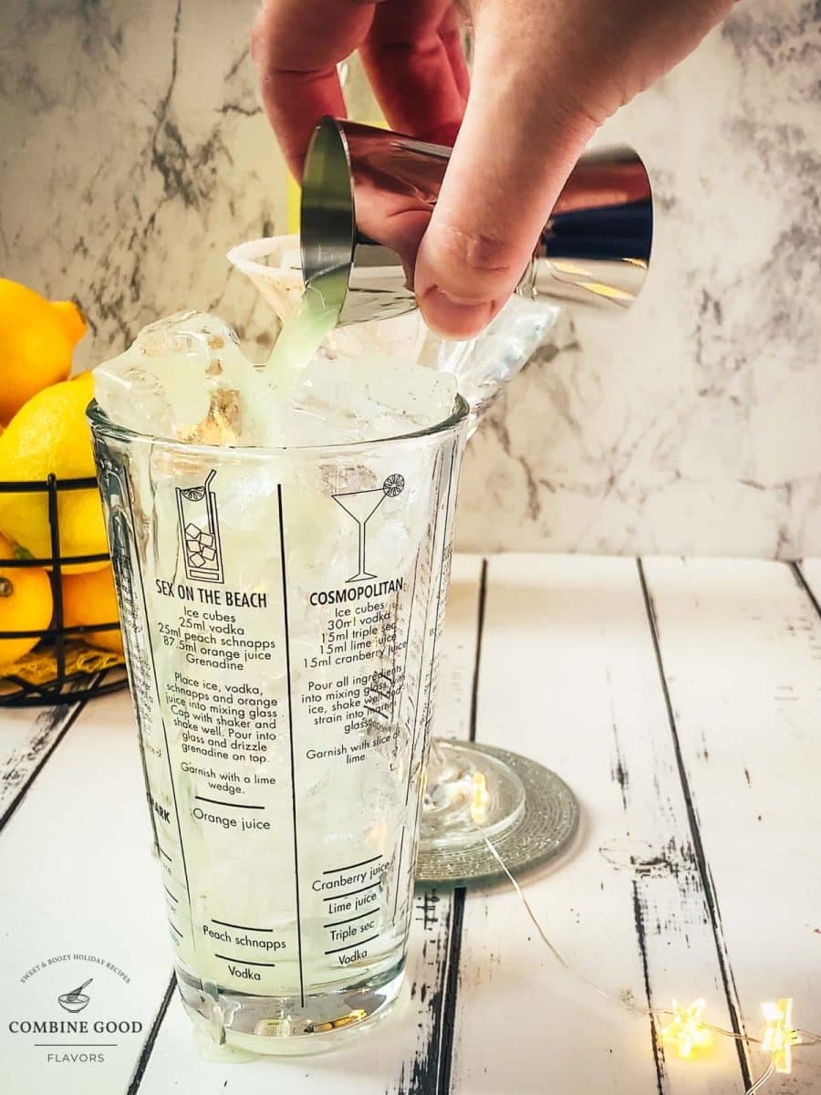 Adding the Limoncello to the cocktail shaker.