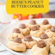 Utterly delicious Reese's peanut butter cookies served on a white plate, with a Reese's peanut butter mini cup on top.