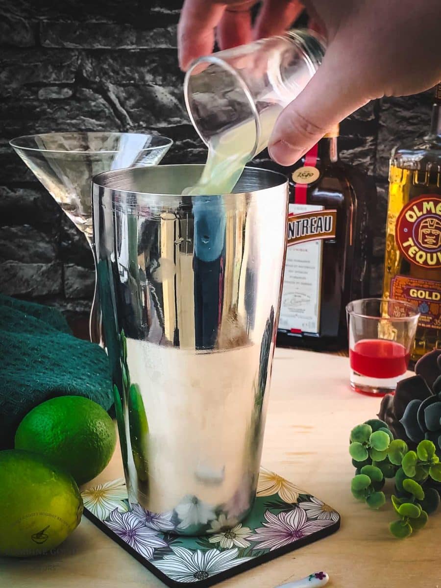 Add Lime juice to the cocktail shaker.