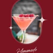 Delicious raspberry margarita served in cocktail glass and garnished with fresh raspberries on a cocktail spike.