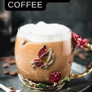 Delicious french press iced coffee served in gorgeous glass mug decorated with roses and butterflies.