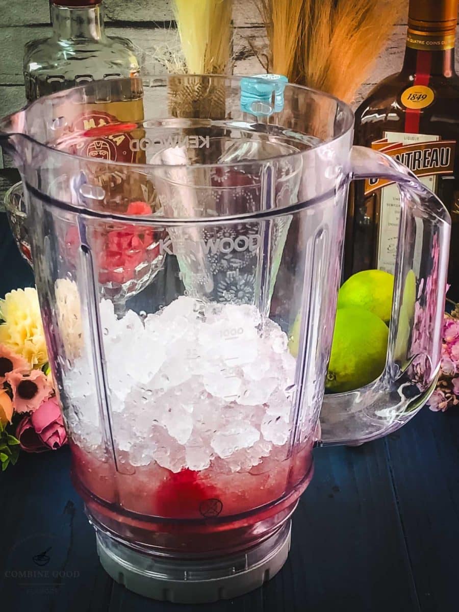 Add crushed ice to the mix in the blender.