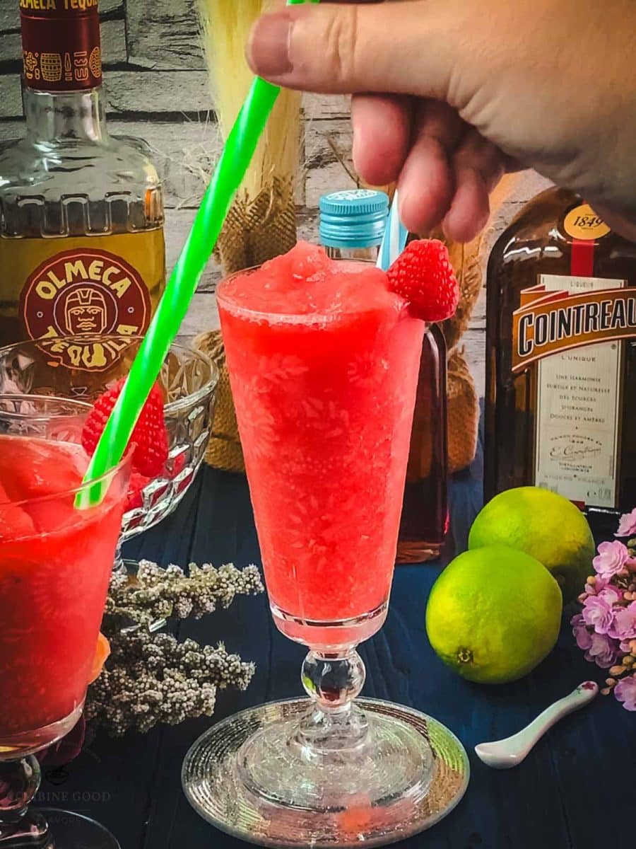 Serve the frozen raspberry margarita with a drinking straw.