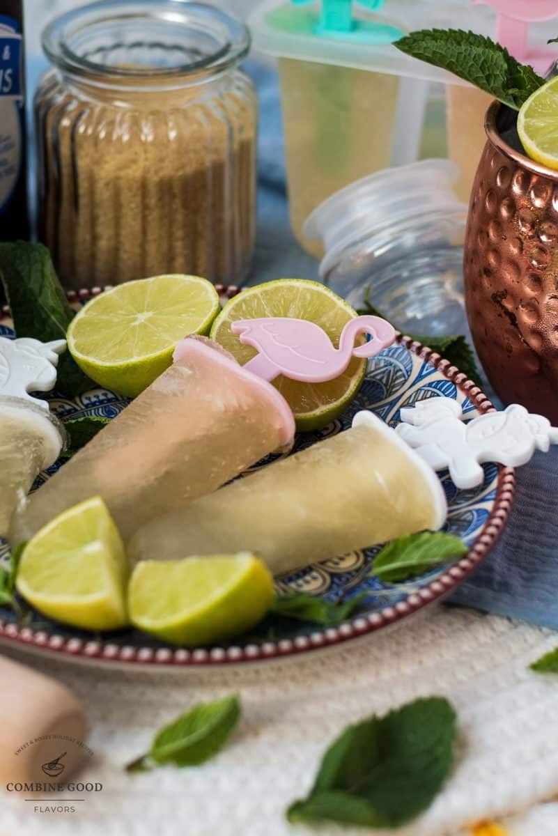 Gorgeous and refreshing Moscow mule popsicles placed on patterned plate.