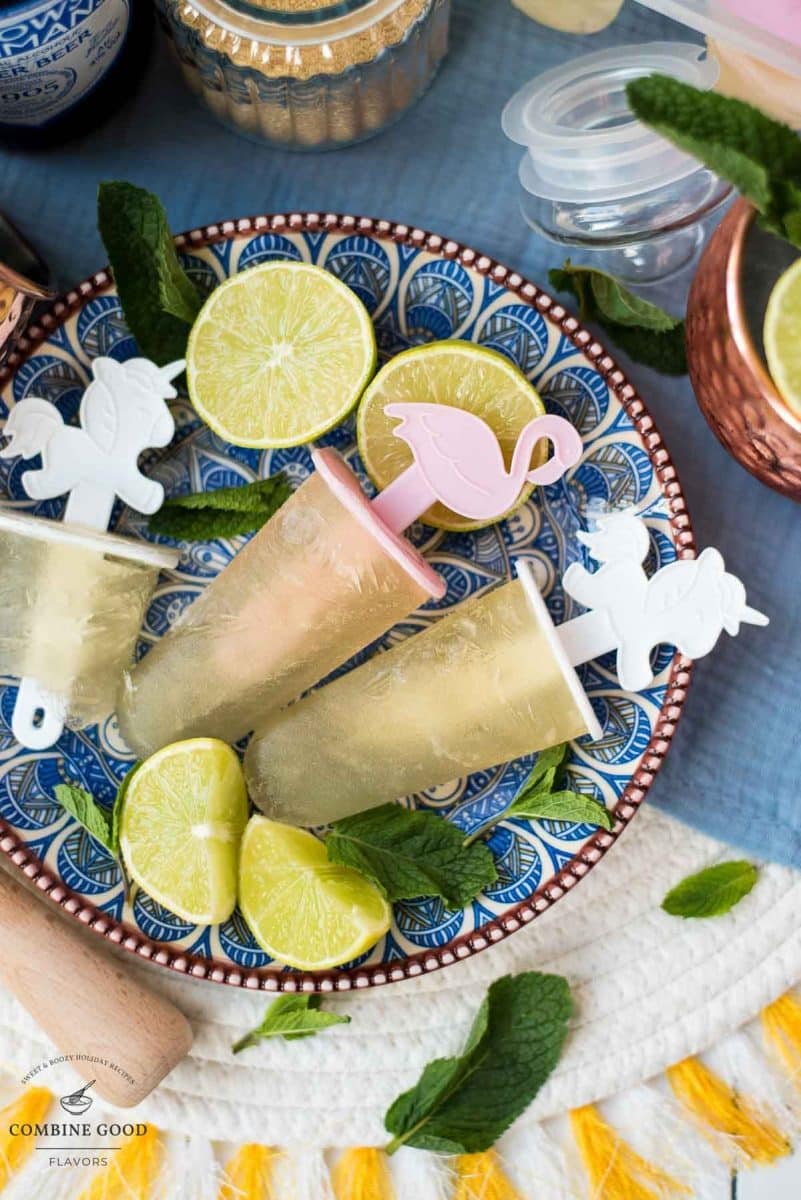 Gorgeous and refreshing Moscow mule popsicles placed on patterned plate.